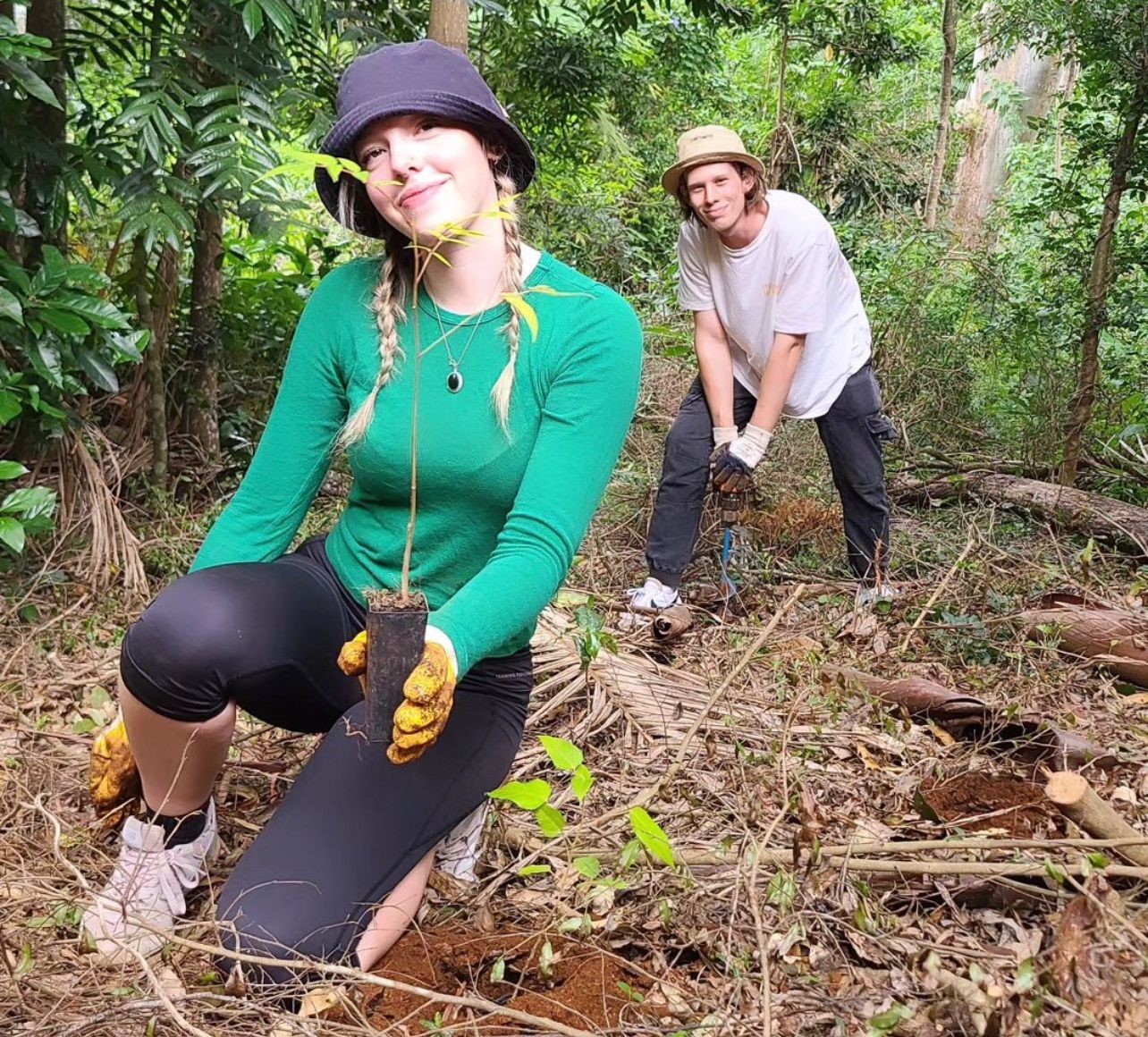 Two young people planting seedlings