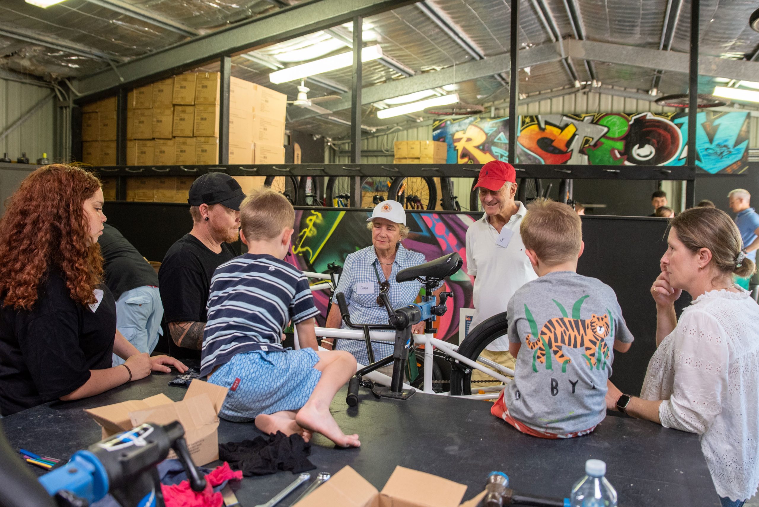 VFFF Rising Gen members learn how to assemble a bike with TRACTION mentors.