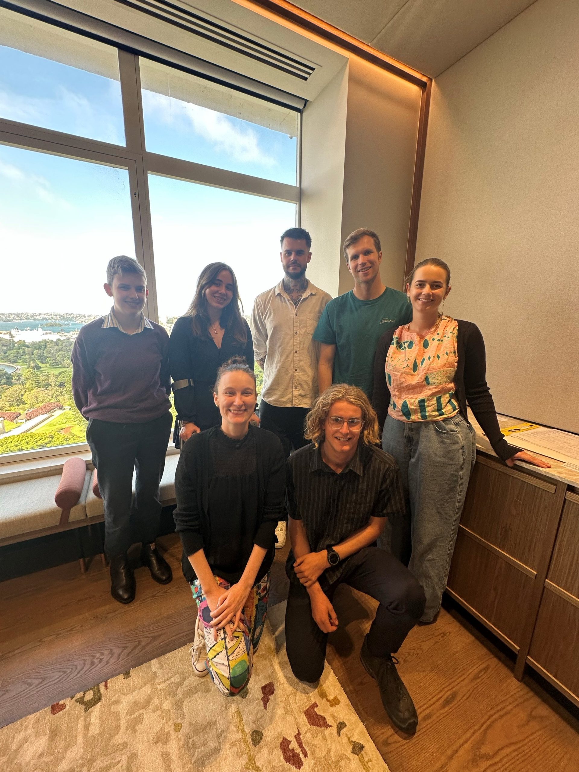 The Youth Advisory Group together in front of a window during a meeting