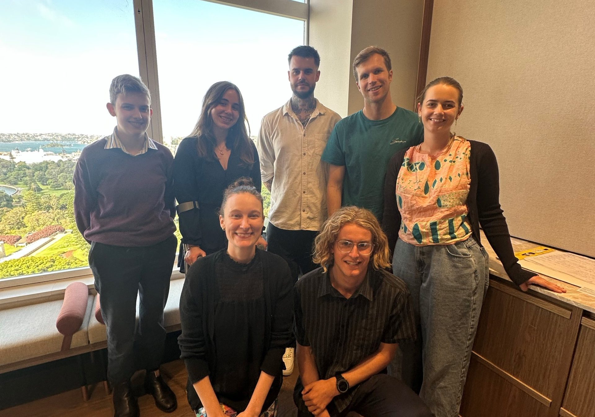 The Youth Advisory Group together in front of a window during a meeting