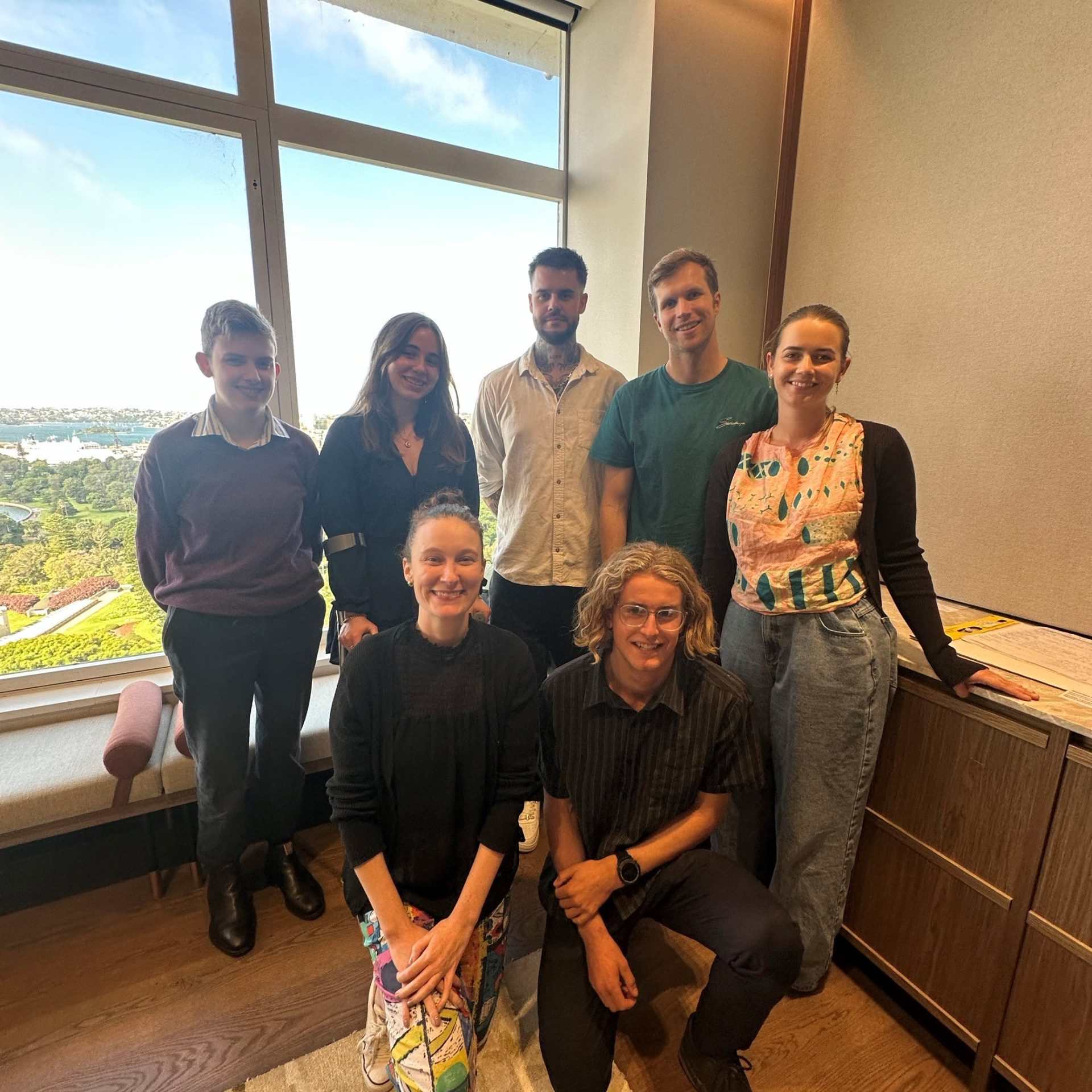 The Youth Advisory Group together in front of a window during a meeting